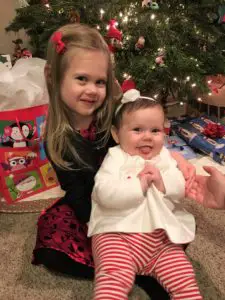 Girls in front of Christmas tree