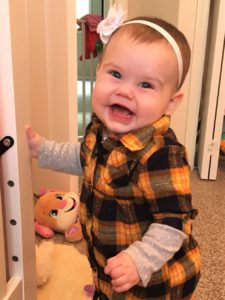 Ellie standing by crib