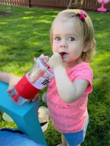 Ellie drinking with a straw.