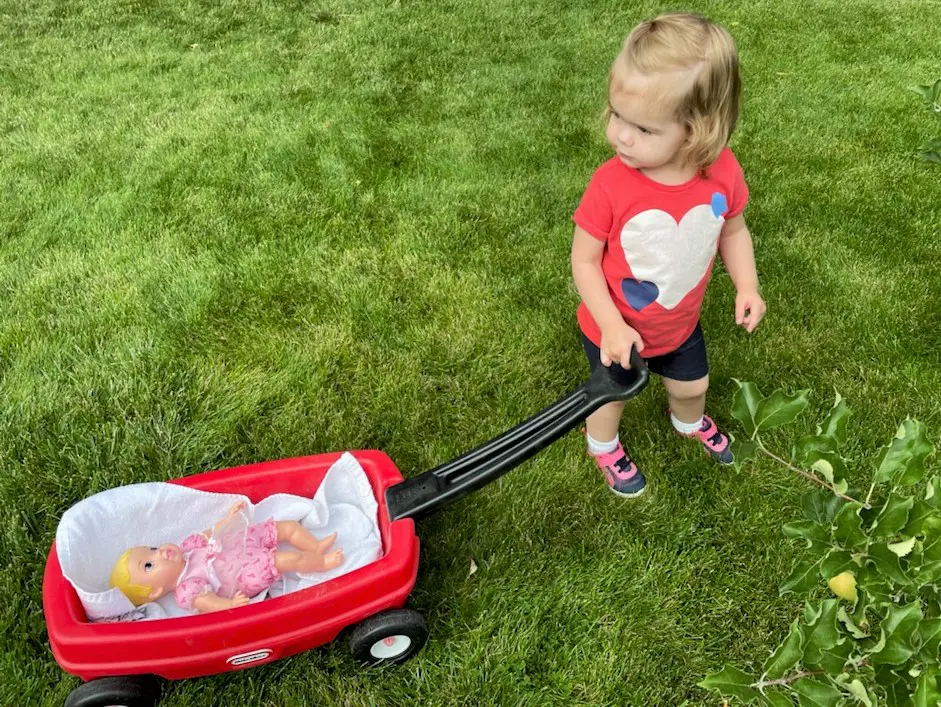 Ellie pulling baby in wagon