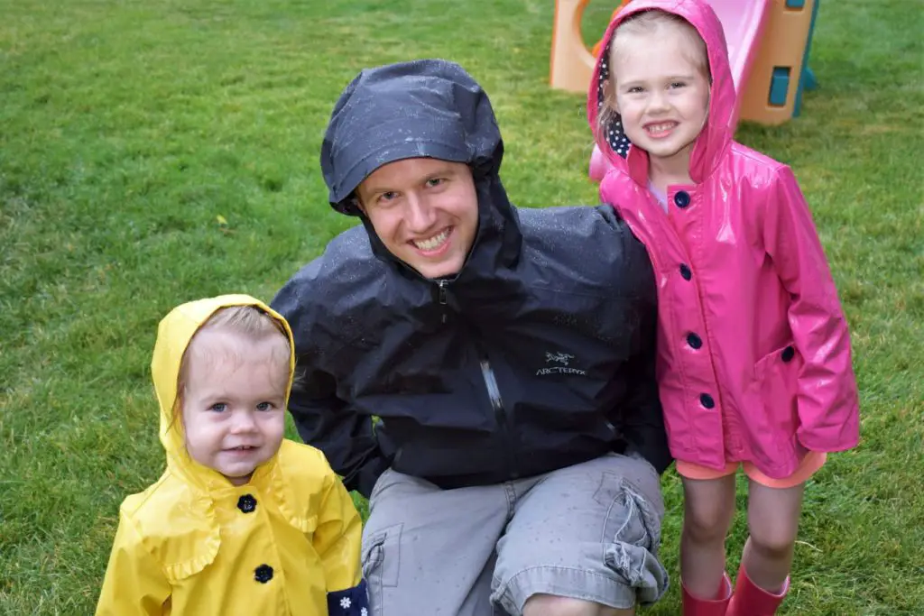 Dad and daughters in the rain