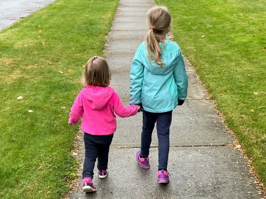 Girls holding hands on a walk