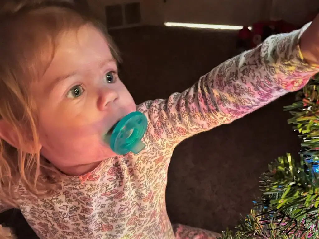 girl lit by christmas lights