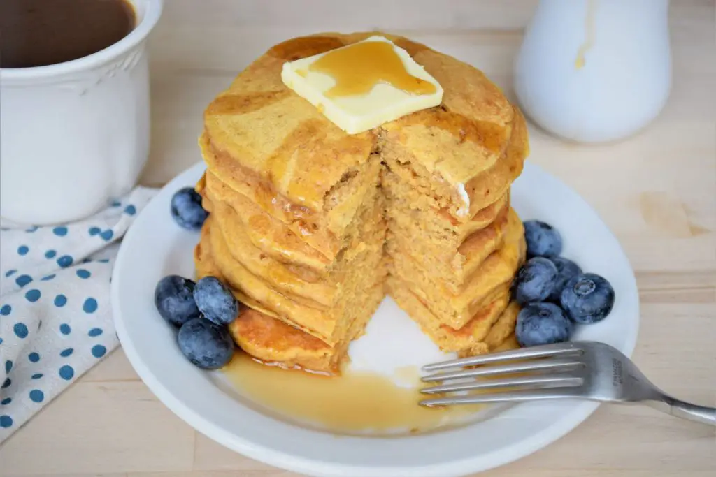 Bite out of a stack of butternut squash pancakes