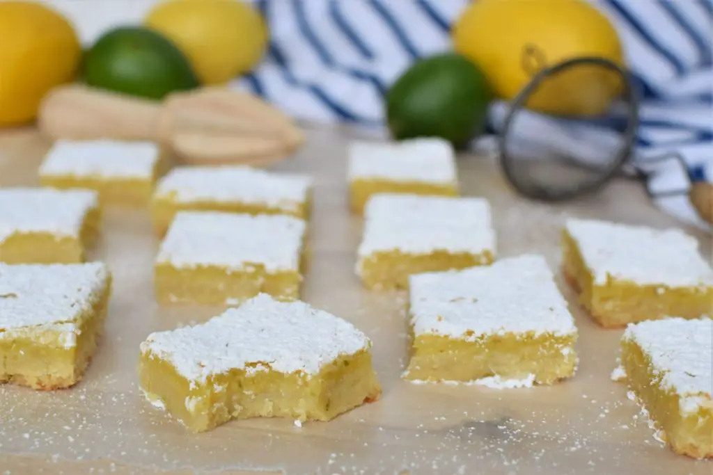 Lemon lime bars on a counter, one bite out - this bread will rise