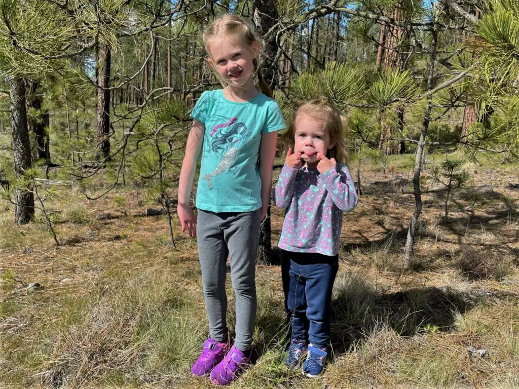 Two girls in the woods, one with tongue out - this bread will rise