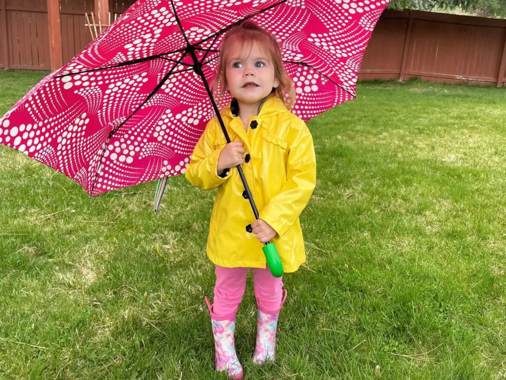 young girl with pink umbrella - this bread will rise