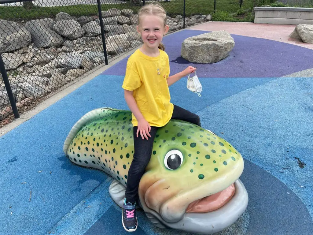 Girl sitting on a fish