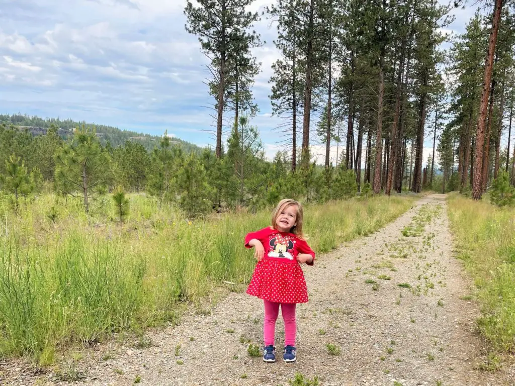 Young girl being silly on a trail