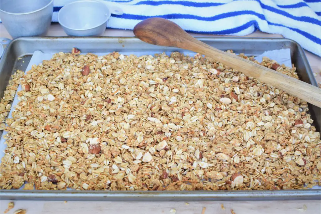 Sheet pan lined with parchment paper with granola on top. This bread will rise