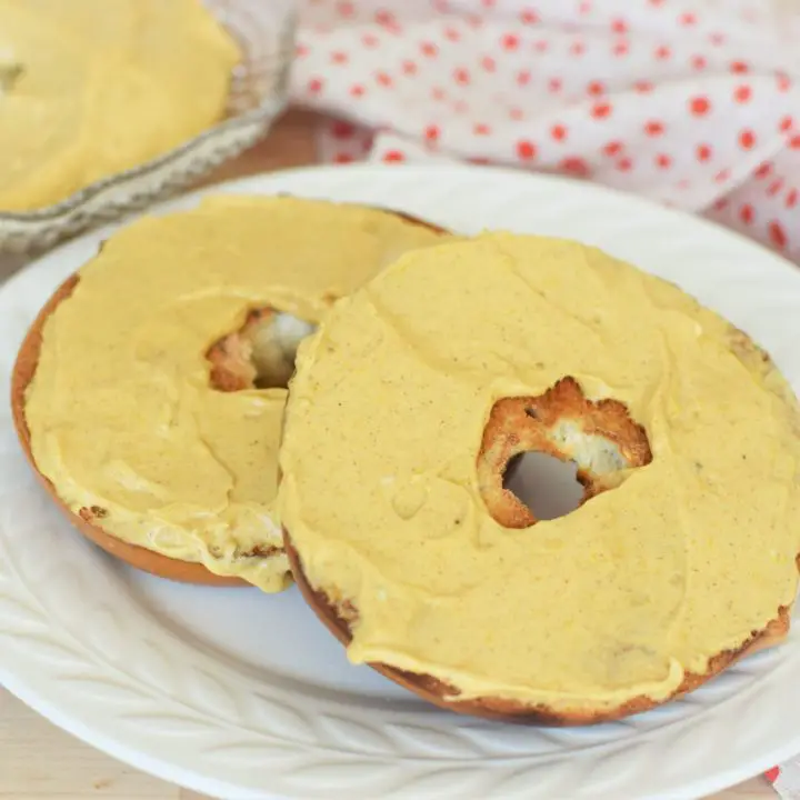 Pumpkin cream cheese spread on toasted bagels