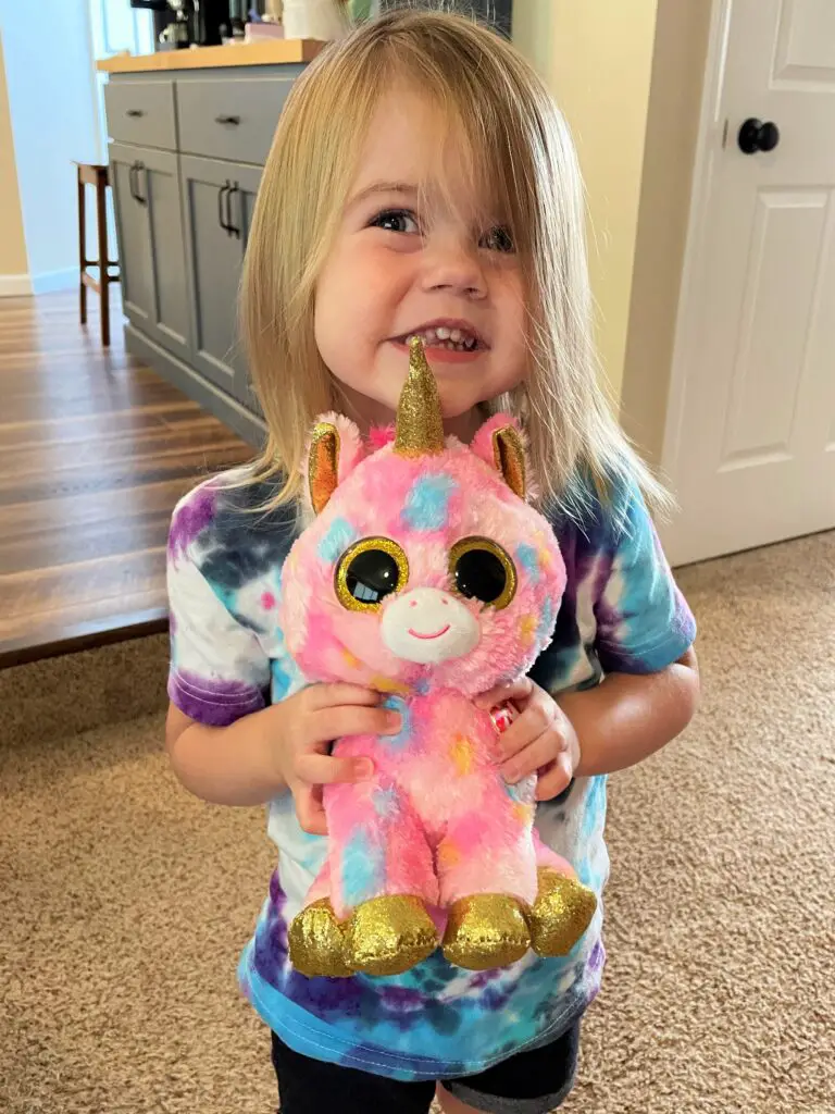 Girl holding stuffed unicorn - this bread will rise