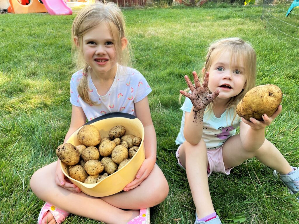 Two girls holding potatoes - this bread will rise