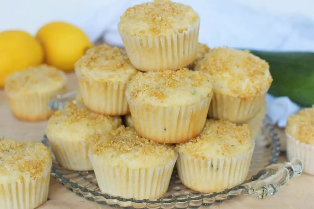 Tower of lemon zucchini muffins on pretty glass platter - this bread will rise