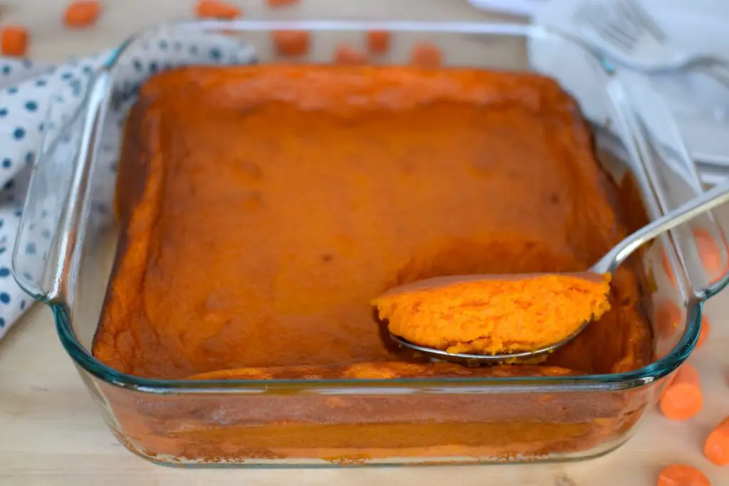 Carrot souffle with a portion scooped up. This bread will rise