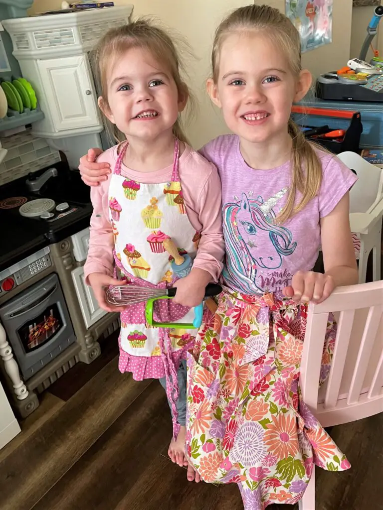 Two young girls in aprons
