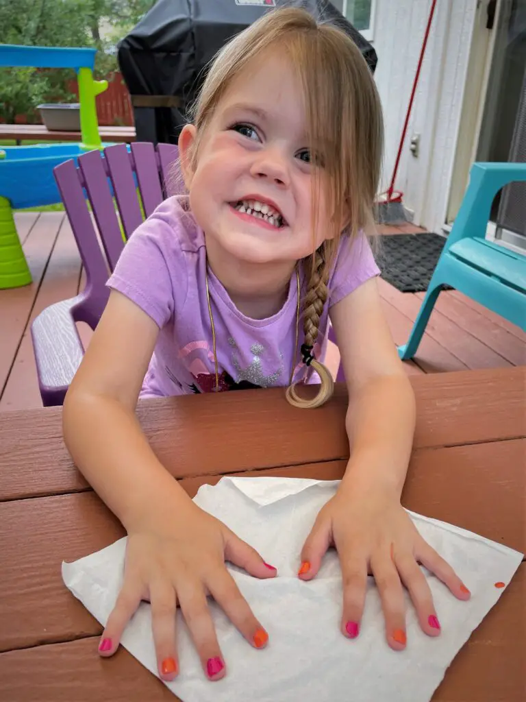 Ellie with nails painted orange and pink - this bread will rise