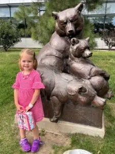 Ellie next to a bear statue