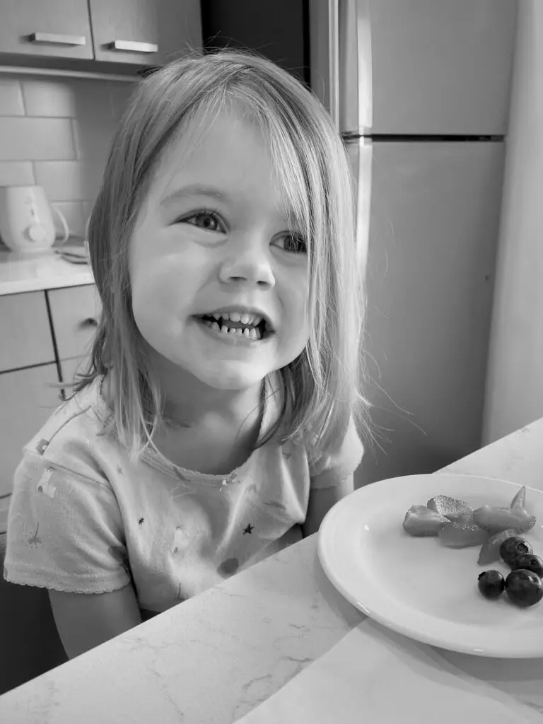 Ellie eating blueberries and strawberries.