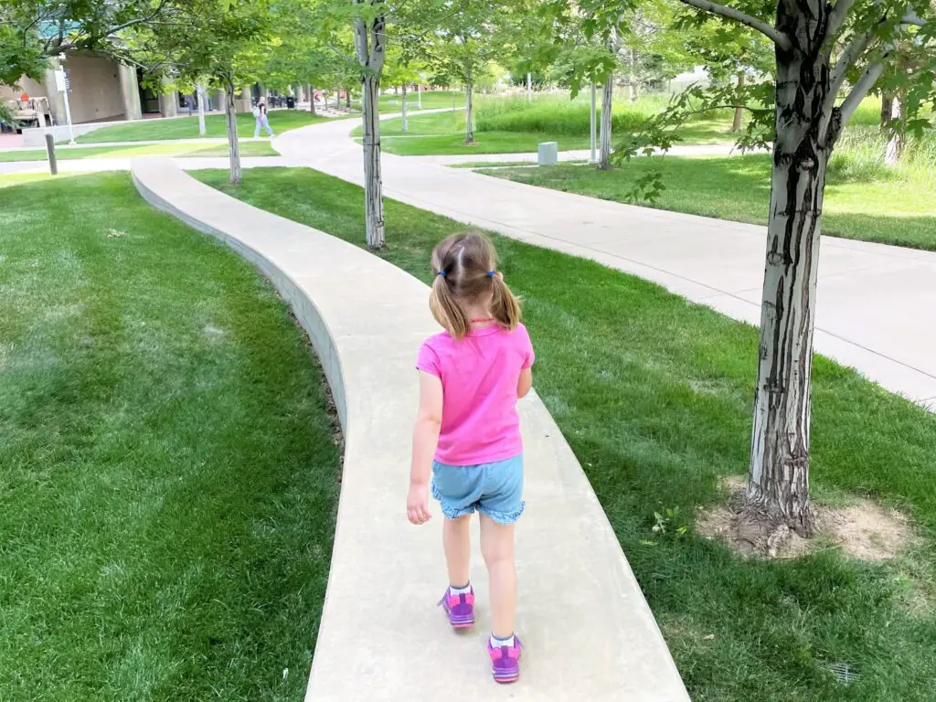 Ellie walking on raised winding pathway.