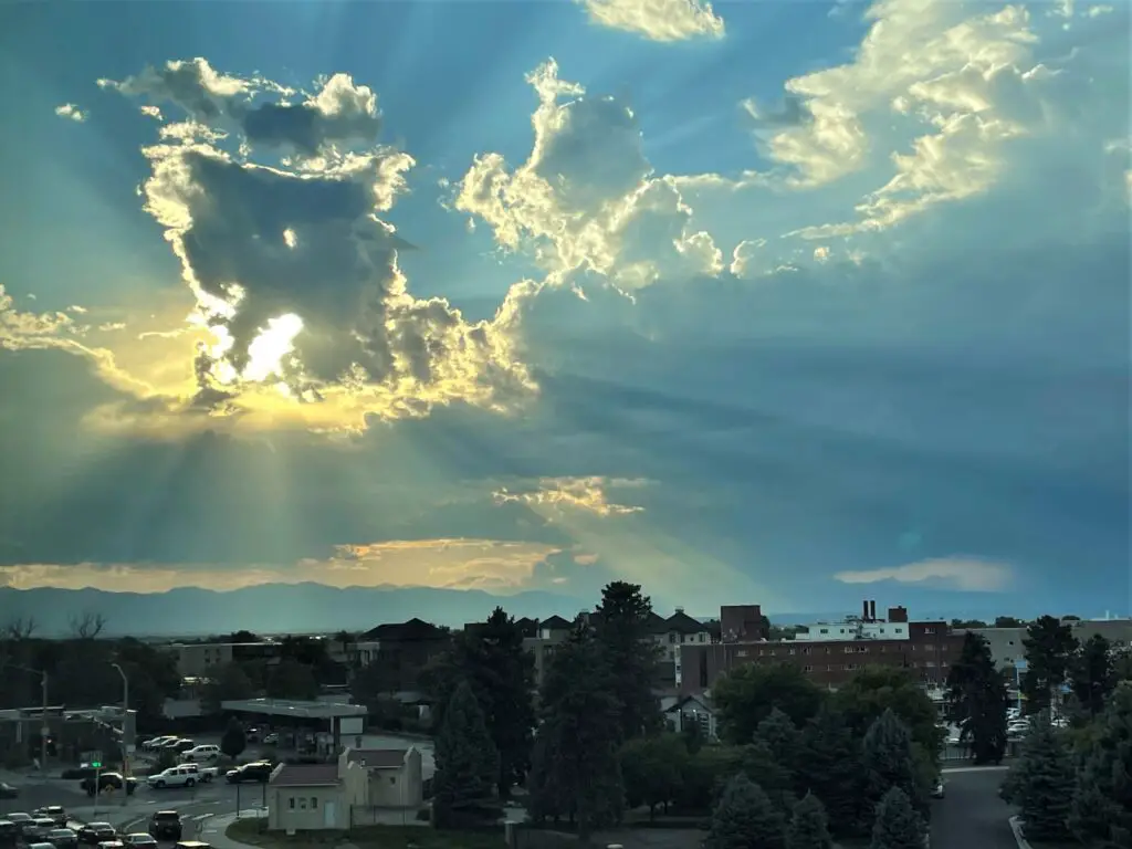 Beautiful sky picture with the sun shining through the clouds close to sunset.