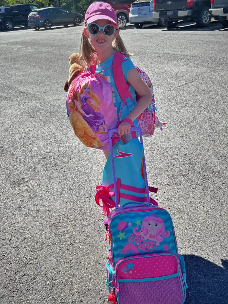 Rosie in all pink and teal with all her bags that are also pink and teal.