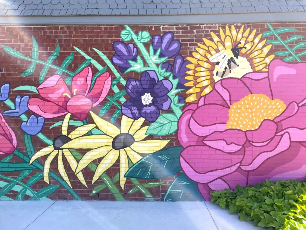 Colorful flower mural on brick wall