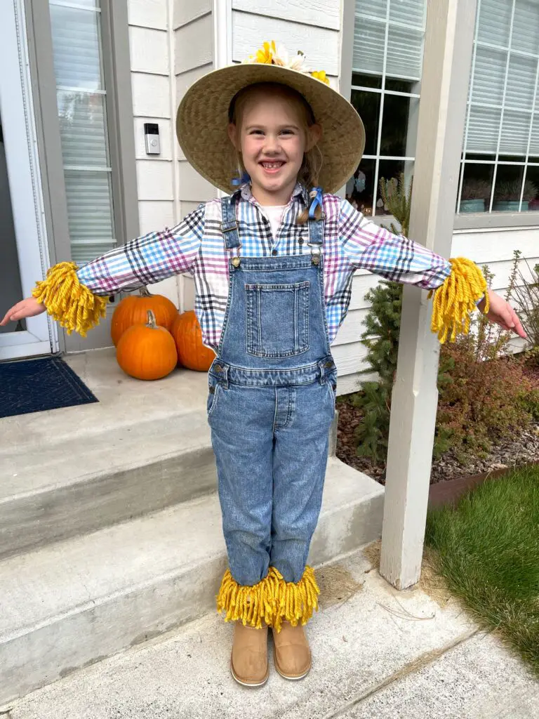 Rosie as a scarecrow for halloween. Overalls, button up shirt, straw hat, and yarn fringe around wrists and ankles. This bread will rise